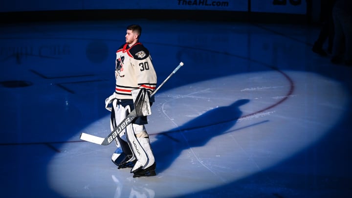 Milwaukee Admirals goaltender Yaroslav Askarov stands in the spotlight during pregame ceremonies before a game against the Texas Stars on Friday, January 19, 2024, at the UW-Milwaukee Panther Arena in Milwaukee, Wisconsin.