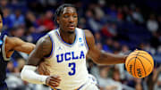 Mar 20, 2025; Lexington, KY, USA;  UCLA Bruins guard Eric Dailey Jr. (3) drives to the basket against Utah State Aggies guard Dexter Akanno (7) during the second half in the first round of the NCAA Tournament at Rupp Arena. Mandatory Credit: Jordan Prather-Imagn Images