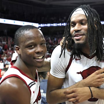 Arkansas Razorbacks guard Johnell Davis (1) celebrates with forwards Jonas Aidoo (9) and Karter Knox (11) after the game against the Mississippi State Bulldogs at Bud Walton Arena in Fayetteville, Ark.