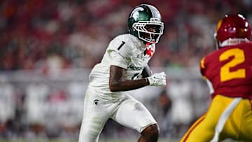 Sep 20, 2025; Los Angeles, California, USA; Michigan State Spartans wide receiver Omari Kelly (1) runs the ball against Southern California Trojans cornerback DJ Harvey (2) during the first half at the Los Angeles Memorial Coliseum. Mandatory Credit: Gary A. Vasquez-Imagn Images