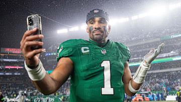 Nov 26, 2023; Philadelphia, Pennsylvania, USA; Philadelphia Eagles quarterback Jalen Hurts (1) reacts with a smart phone while walking off the field after an overtime victory against the Buffalo Bills at Lincoln Financial Field. Mandatory Credit: Bill Streicher-Imagn Images