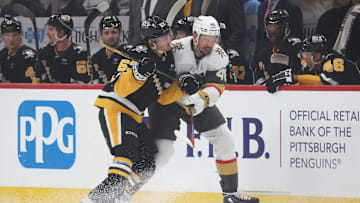 Mar 11, 2025; Pittsburgh, Pennsylvania, USA;  Pittsburgh Penguins center Philip Tomasino (53) checks Vegas Golden Knights center Tomas Hertl (48) during the first period at PPG Paints Arena. Mandatory Credit: Charles LeClaire-Imagn Images