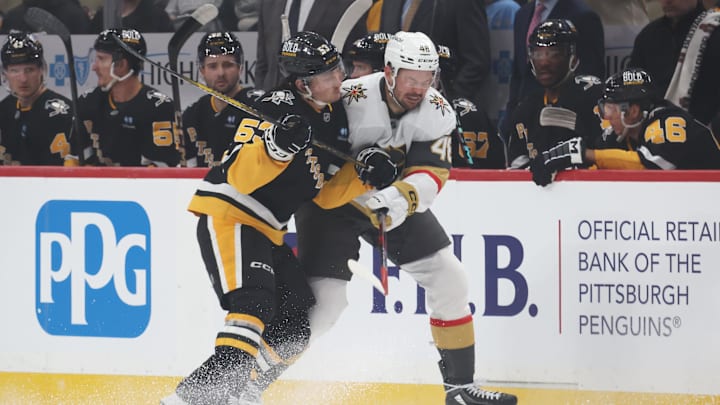Mar 11, 2025; Pittsburgh, Pennsylvania, USA;  Pittsburgh Penguins center Philip Tomasino (53) checks Vegas Golden Knights center Tomas Hertl (48) during the first period at PPG Paints Arena. Mandatory Credit: Charles LeClaire-Imagn Images
