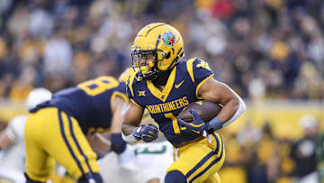 Nov 16, 2024; Morgantown, West Virginia, USA; West Virginia Mountaineers running back Jahiem White (1) runs the ball during the first quarter against the Baylor Bears at Mountaineer Field at Milan Puskar Stadium. Mandatory Credit: Ben Queen-Imagn Images