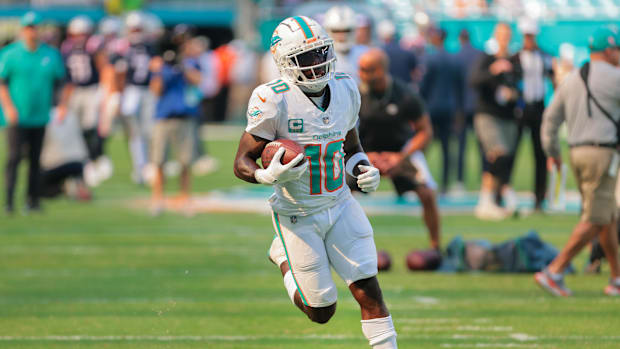 Nov 24, 2024; Miami Gardens, Florida, USA; Miami Dolphins wide receiver Tyreek Hill (10) runs with the football before the ga