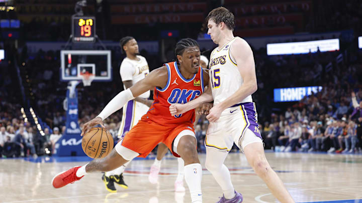 Dec 23, 2023; Oklahoma City, Oklahoma, USA; Oklahoma City Thunder forward Jalen Williams (8) drives against Los Angeles Lakers guard Austin Reaves (15) during the second half at Paycom Center. Mandatory Credit: Alonzo Adams-Imagn Images