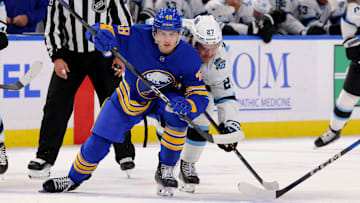 Dec 7, 2024; Buffalo, New York, USA;  Buffalo Sabres center Tyson Kozak (48) wins a face-off against Utah Hockey Club center Barrett Hayton (27) during the first period at KeyBank Center. Mandatory Credit: Timothy T. Ludwig-Imagn Images