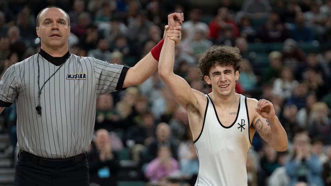 Saint John Vianney’s Anthony Knox’s hand is raised after defeating Bergen Catholic’s Nathan Braun in the championship XX match during finals of the NJSIAA individual wrestling state championships at Boardwalk Hall in Atlantic City on Friday, March 8, 2025. Saint John Vianney’s Anthony Knox is awarded the 126lb state championship title and is a 4-time state champion.