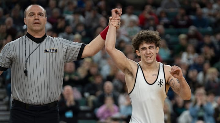 Saint John Vianney’s Anthony Knox’s hand is raised after defeating Bergen Catholic’s Nathan Braun in the championship XX match during finals of the NJSIAA individual wrestling state championships at Boardwalk Hall in Atlantic City on Friday, March 8, 2025. Saint John Vianney’s Anthony Knox is awarded the 126lb state championship title and is a 4-time state champion.