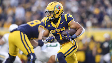 Nov 16, 2024; Morgantown, West Virginia, USA; West Virginia Mountaineers running back Jahiem White (1) runs the ball during the first quarter against the Baylor Bears at Mountaineer Field at Milan Puskar Stadium. Mandatory Credit: Ben Queen-Imagn Images