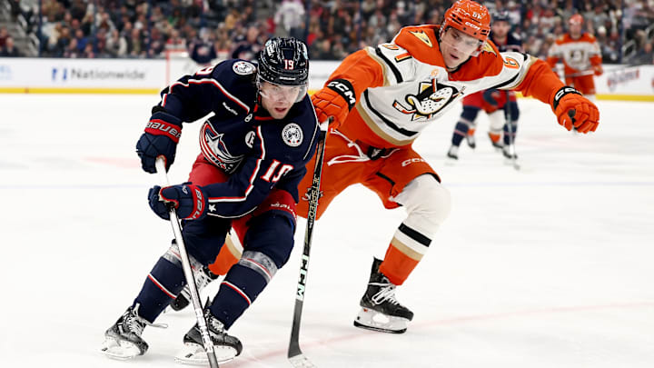 Blue Jackets center Adam Fantilli protects the puck against Ducks forward Cutter Gauthier.