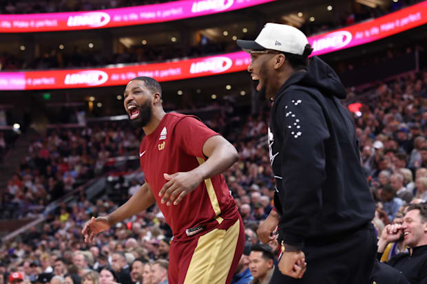 Tristan Thompson and Donovan Mitchell react on the bench 