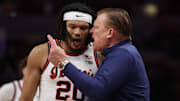 Mar 17, 2024; Minneapolis, MN, USA; Illinois Fighting Illini forward Ty Rodgers (20) talks with head coach Brad Underwood in the second half against the Wisconsin Badgers at Target Center. Mandatory Credit: Matt Krohn-Imagn Images