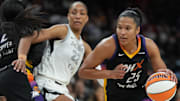 Aug 15, 2025; Phoenix, Arizona; Phoenix Mercury forward Alyssa Thomas (25) drives around Las Vegas Aces center A'ja Wilson (22) in the second half at Footprint Center. 