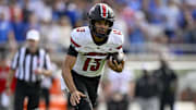 Nov 22, 2025; Dallas, Texas, USA; Louisville Cardinals quarterback Deuce Adams (13) runs with the ball against the SMU Mustangs during the first half at Gerald J. Ford Stadium. Mandatory Credit: Jerome Miron-Imagn Images