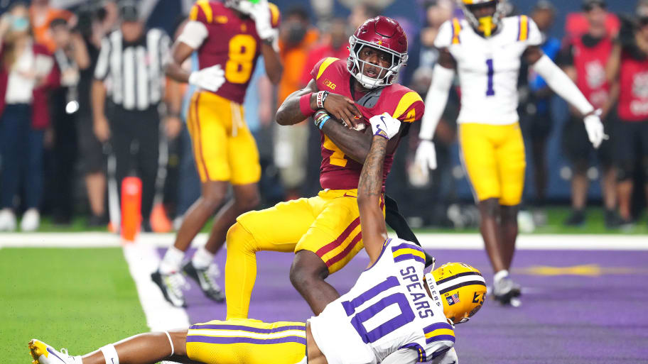 Trojans running back Woody Marks breaks the tackle of Tigers safety Dashawn Spears to score the winning touchdown.