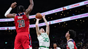 Nov 5, 2025; Boston, Massachusetts, USA; Boston Celtics forward Sam Hauser (30) shoots against Washington Wizards center Alex Sarr (20) in the second half at TD Garden. Mandatory Credit: David Butler II-Imagn Images
