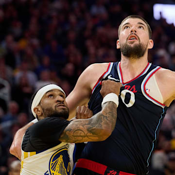 Apr 13, 2025; San Francisco, California, USA; Golden State Warriors guard Gary Payton II (0) and guard Stephen Curry (30) vie for position against LA Clippers center Ivica Zubac (40) during the fourth quarter at Chase Center. Mandatory Credit: Robert Edwards-Imagn Images