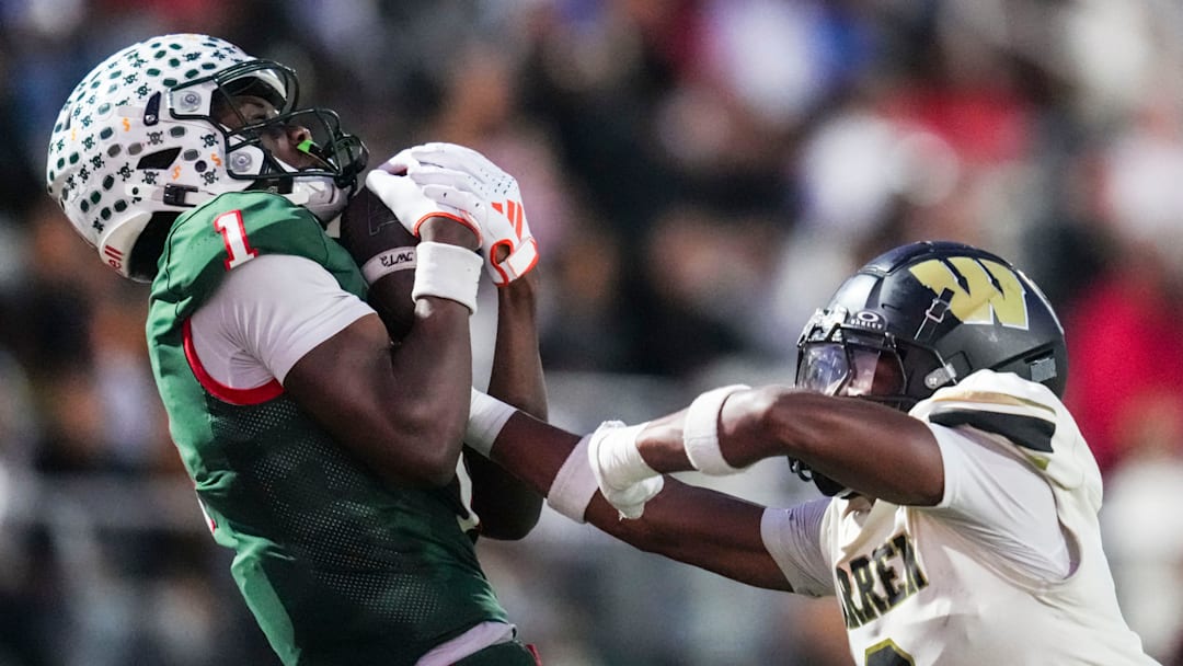 Lawrence North Wildcats Monshun Sales (1) catches a pass against Warren Central Terrell Harris (2) on Friday, Oct. 3, 2025, during a game between the Lawrence North Wildcats and Warren Central at Lawrence North High School in Indianapolis.