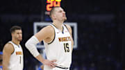 May 18, 2025; Oklahoma City, Oklahoma, USA; Denver Nuggets center Nikola Jokic (15) watches Oklahoma City Thunder guard Shai Gilgeous-Alexander shoot free throws in the second half of game seven of the second round for the 2025 NBA Playoffs at Paycom Center. Mandatory Credit: Alonzo Adams-Imagn Images