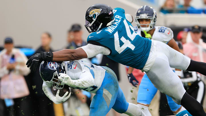 Jacksonville Jaguars defensive end Travon Walker tackles Tennessee Titans running back Julius Chestnut during a game. Jacksonville Jaguars defensive end Travon Walker tackles Tennessee Titans running back Julius Chestnut during a game.