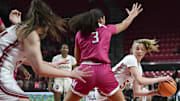 Indiana Hoosiers guard Lenee Beaumont (5) passes around Maryland Terrapins guard Lavender Briggs (3) to forward Mackenzie Holmes (54) during the first half at Xfinity Center in 2024.
