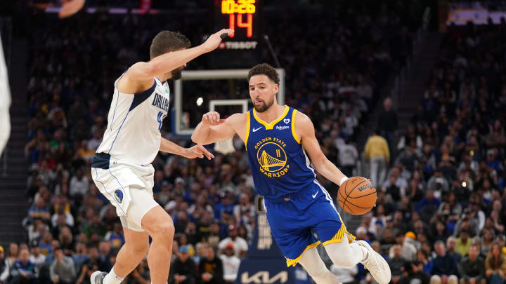 Apr 2, 2024; San Francisco, California, USA; Golden State Warriors guard Klay Thompson (11) dribbles the ball next to Dallas Mavericks forward Maxi Kleber (42) in the fourth quarter at the Chase Center. Mandatory Credit: Cary Edmondson-USA TODAY Sports
