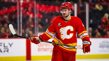 Apr 11, 2025; Calgary, Alberta, CAN; Calgary Flames defenseman Rasmus Andersson (4) against the Minnesota Wild during the second period at Scotiabank Saddledome. Mandatory Credit: Sergei Belski-Imagn Images