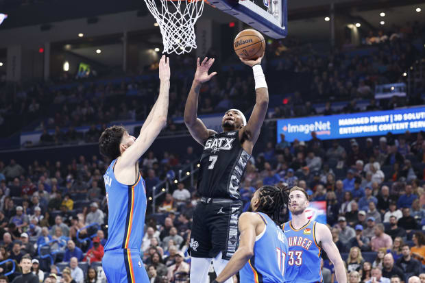 San Antonio Spurs guard David Duke Jr. (7) shoots as Oklahoma City Thunder forward Chet Holmgren (7) defends at Paycom Center