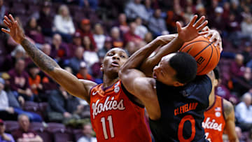 Jan 4, 2025; Blacksburg, Virginia, USA; Virginia Tech Hokies guard Ben Hammond (11) and Miami Hurricanes guard Matthew Cleveland (0) go for the ball during the second half at Cassell Coliseum. Mandatory Credit: Peter Casey-Imagn Images