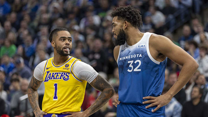 Dec 21, 2023; Minneapolis, Minnesota, USA; Los Angeles Lakers guard D'Angelo Russell (1) and Minnesota Timberwolves center Karl-Anthony Towns (32) talk during a free throw in the first half at Target Center. Mandatory Credit: Jesse Johnson-Imagn Images