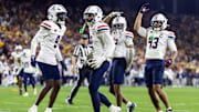 Nov 28, 2025; Tempe, Arizona, USA; Arizona Wildcats defensive back Treydan Stukes (2) celebrates with defensive back Ayden Garnes (9) after an interception against Arizona State Sun Devils in the second half during the 99th Territorial Cup at Mountain America Stadium. Mandatory Credit: Mark J. Rebilas-Imagn Images