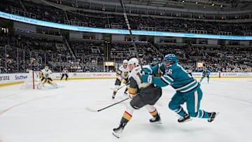 Sep 26, 2025; San Jose, California, USA; San Jose Sharks right wing Ethan Cardwell (56) vies for position against Vegas Golden Knights defenseman Ben Hutton (17) with center Tanner Laczynski (28) and goaltender Akira Schmid (40) during the second period at SAP Center at San Jose. Mandatory Credit: Robert Edwards-Imagn Images