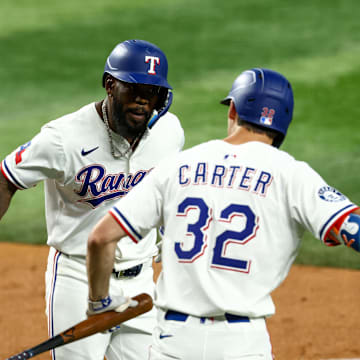 Jul 22, 2025; Arlington, Texas, USA; Texas Rangers right fielder Adolis Garcia (53) celebrates with Texas Rangers center fielder Evan Carter (32) after hitting a home run during the fourth inning against the Athletics at Globe Life Field. Mandatory Credit: Kevin Jairaj-Imagn Images