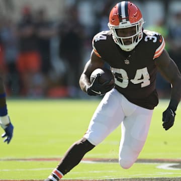 Sep 8, 2024; Cleveland, Ohio, USA; Cleveland Browns running back Jerome Ford (34) runs with the ball as Dallas Cowboys linebacker DeMarvion Overshown (13) defends during the first quarter at Huntington Bank Field.