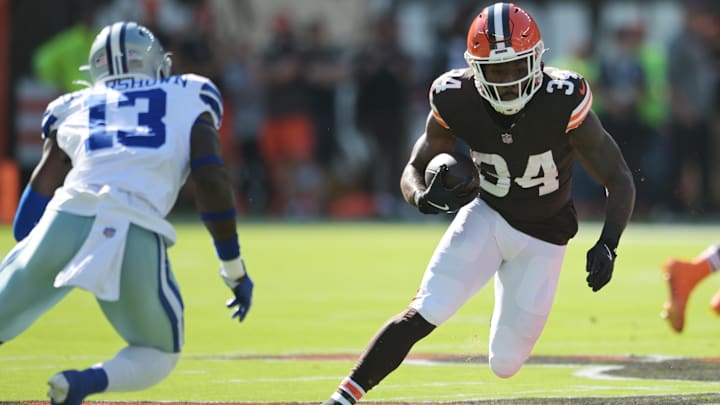 Sep 8, 2024; Cleveland, Ohio, USA; Cleveland Browns running back Jerome Ford (34) runs with the ball as Dallas Cowboys linebacker DeMarvion Overshown (13) defends during the first quarter at Huntington Bank Field.