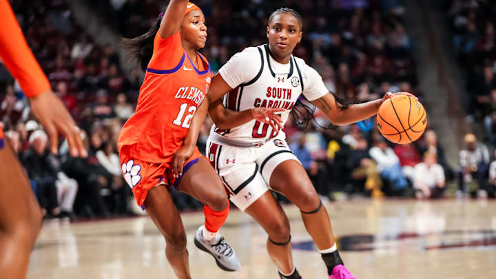 Nov 11, 2025; Columbia, South Carolina, USA; South Carolina Gamecocks guard Ta'Niya Latson (00) drives around Clemson Tigers guard Mia Moore (12) in the first half at Colonial Life Arena. Mandatory Credit: Jeff Blake-Imagn Images