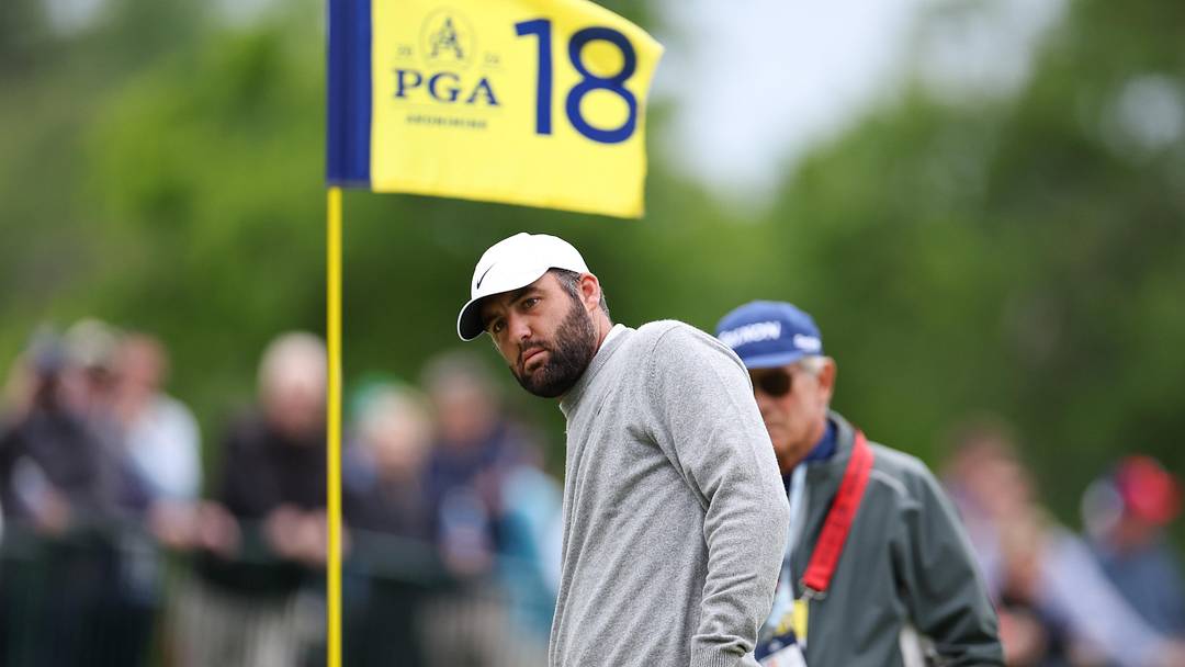 Scottie Scheffler putts on the 18th green during a practice round of the 2026 PGA Championship at Aronimink Golf Club