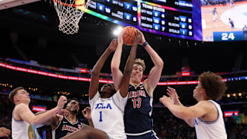 Nov 14, 2025; Inglewood, California, USA;  Arizona Wildcats center Motiejus Krivas (13) fights for a rebound against UCLA Bruins center Xavier Booker (1) during the first half of the Hall of Fame Series game at Intuit Dome. Mandatory Credit: Kiyoshi Mio-Imagn Images