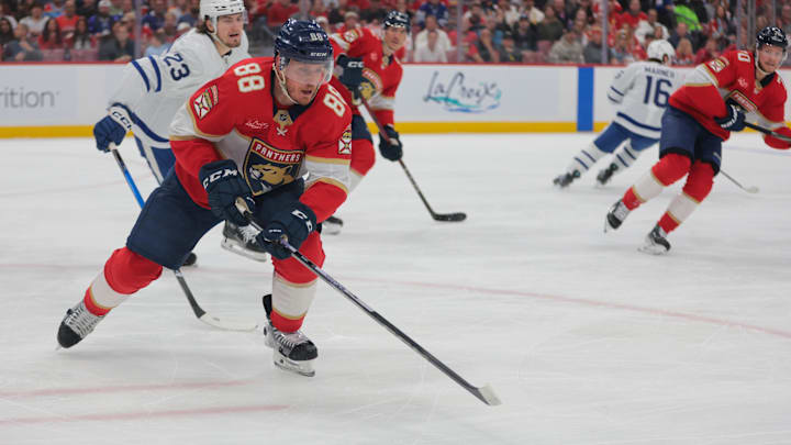 May 16, 2025; Sunrise, Florida, USA; Florida Panthers defenseman Nate Schmidt (88) moves the puck past Toronto Maple Leafs left wing Matthew Knies (23) during the first period in game six of the second round of the 2025 Stanley Cup Playoffs at Amerant Bank Arena. Mandatory Credit: Sam Navarro-Imagn Images