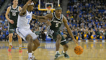 Feb 4, 2025; Los Angeles, California, USA; Michigan State Spartans guard Tre Holloman (5) drives past UCLA Bruins guard Dylan Andrews (2) in the second half at Pauley Pavilion presented by Wescom. Mandatory Credit: Jayne Kamin-Oncea-Imagn Images