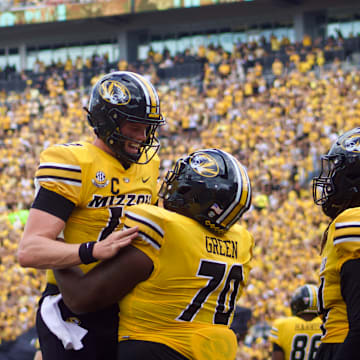 Sep 14, 2024; Columbia, Missouri, USA; Missouri Tigers quarterback Brady Cook (12) celebrates with Tigers offensive lineman Cayden Green (70) following a touchdown against the Boston College Eagles at Faurot Field at Memorial Stadium.