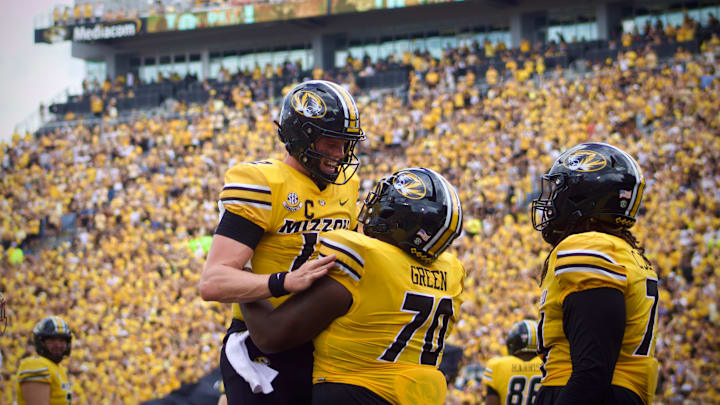 Sep 14, 2024; Columbia, Missouri, USA; Missouri Tigers quarterback Brady Cook (12) celebrates with Tigers offensive lineman Cayden Green (70) following a touchdown against the Boston College Eagles at Faurot Field at Memorial Stadium.