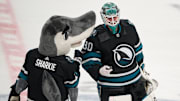Mar 9, 2024; San Jose, California, USA; San Jose Sharks goaltender Magnus Chrona (30) celebrates with San Jose Sharks mascot Sharkie after defeating the against the Ottawa Senators during the third period at SAP Center at San Jose. Mandatory Credit: Robert Edwards-Imagn Images