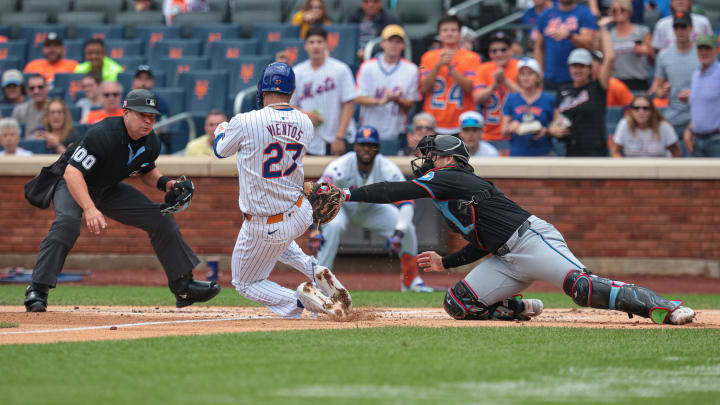 Aug 18, 2024; New York City, New York, USA; Miami Marlins catcher Nick Fortes (4) tags out New York Mets third baseman Mark Vientos (27) at home plate during the first inning at Citi Field.