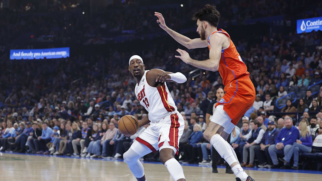 Jan 11, 2026; Oklahoma City, Oklahoma, USA; Oklahoma City Thunder center/forward Chet Holmgren (7) defends a drive by Miami Heat center/forward Bam Adebayo (13) during the first quarter at Paycom Center.
