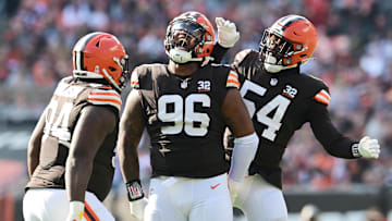 Nov 5, 2023; Cleveland, Ohio, USA; Cleveland Browns defensive tackle Jordan Elliott (96) celebrates a sack with defensive tackle Dalvin Tomlinson (94) and defensive end Ogbo Okoronkwo (54) during the first quarter against the Arizona Cardinals at Cleveland Browns Stadium. Mandatory Credit: Ken Blaze-Imagn Images
