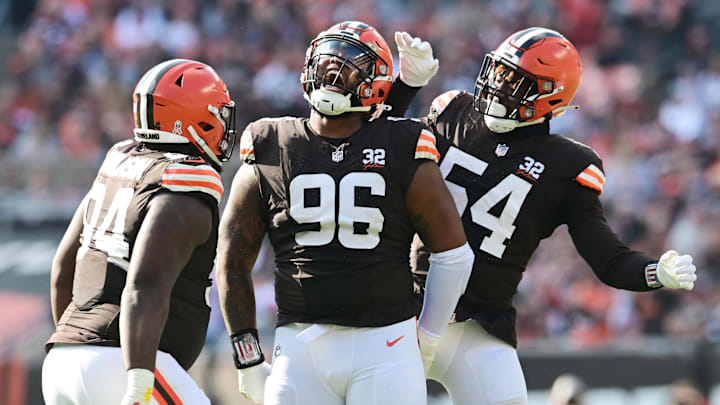 Nov 5, 2023; Cleveland, Ohio, USA; Cleveland Browns defensive tackle Jordan Elliott (96) celebrates a sack with defensive tackle Dalvin Tomlinson (94) and defensive end Ogbo Okoronkwo (54) during the first quarter against the Arizona Cardinals at Cleveland Browns Stadium. Mandatory Credit: Ken Blaze-Imagn Images