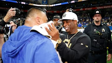 Deion Sanders and Kalani Sitake share congratulations at the end of the Alamo Bowl.