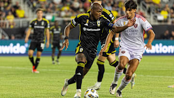 Sep 21, 2024; Columbus, Ohio, USA;  Columbus Crew midfielder Darlington Nagbe (6) dribbles the ball while Orlando City forward Ramiro Enrique (7) defends in the second half at Lower.com Field. Mandatory Credit: Trevor Ruszkowski-Imagn Images